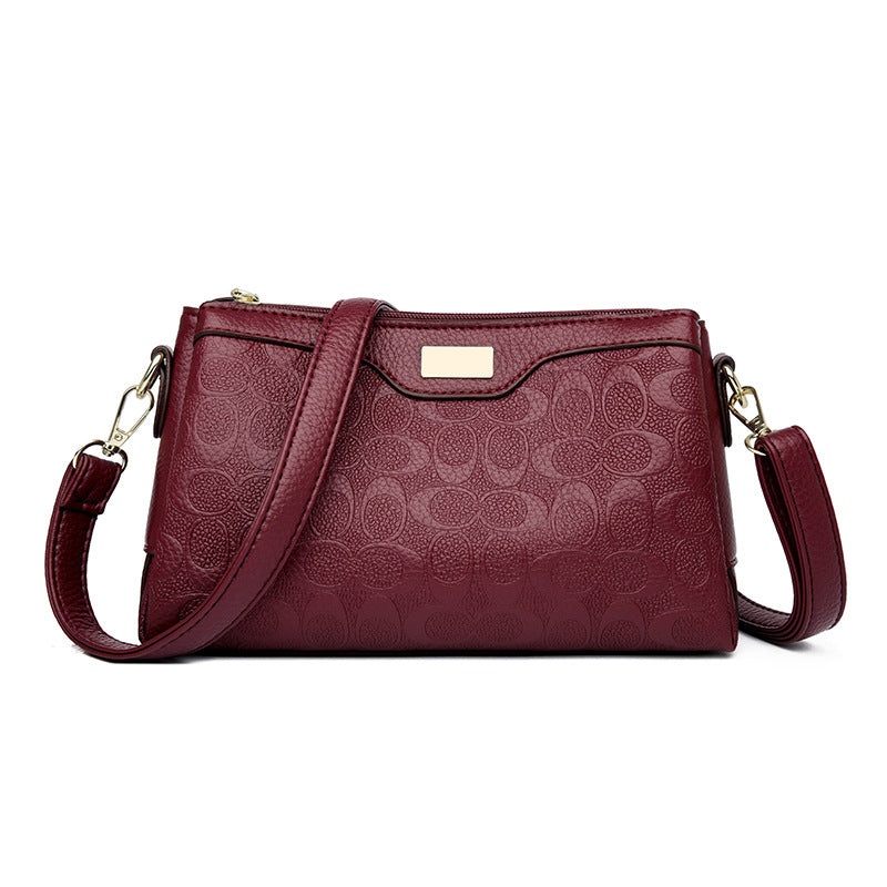 Noir Embossed Accordion Crossbody Bag